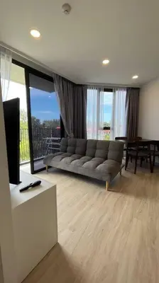 a living room with a couch and a television at Laguna Sky Park Corner 1 Bedroom in Bang Tao Beach