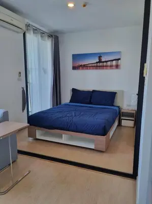 a bedroom with a bed with a blue comforter at Lovely apartment in Bang Tao - Zcape X2 Condo in Phuket Town
