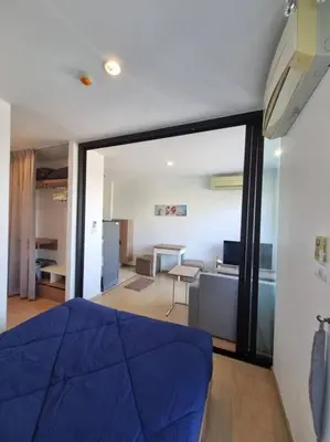 a bedroom with a blue bed and a living room at Lovely apartment in Bang Tao - Zcape X2 Condo in Phuket Town