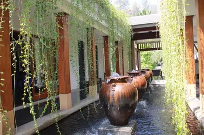 a row of large vases lined up next to a building at Naithon beach WERT in Phuket Town