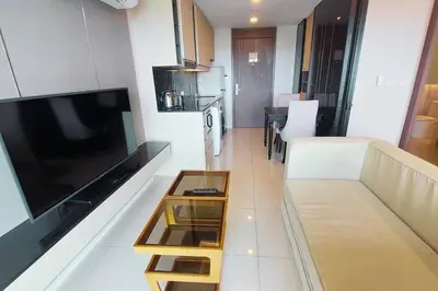 a living room with a couch and a large flat screen tv at Seaview Condo In 5 Star Resort MG1 in Phuket Town