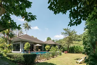 a house with a swimming pool in the yard at VILLA FLORA - North Phuket, Naiyang Beach area in Nai Yang Beach