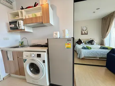 a kitchen with a washer and a bed in a room at Zcape X2 Condos in Bangtao in Bang Tao Beach