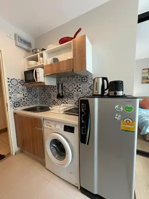 a kitchen with a refrigerator and a washing machine at Zcape X2 Condos in Bangtao in Bang Tao Beach