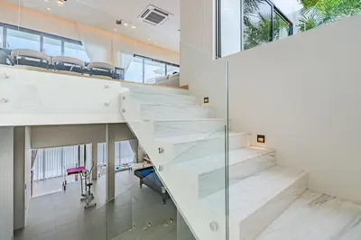 an office with a glass staircase in a building at The Salin Seaview Villas in Kata Beach