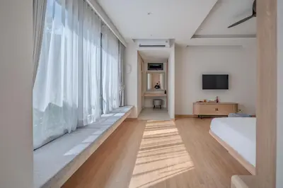 a bedroom with a bed and a large window at The Salin Seaview Villas in Kata Beach
