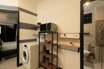 a bathroom with a washing machine and a washer at 1 bdr Apartment Naiharn Beach Condo by CapitalPro in Phuket Town