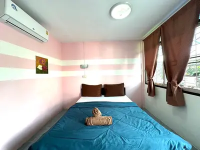 a small bedroom with a bed with a teddy bear on it at THE NAIYANGHOUSE in Nai Yang Beach