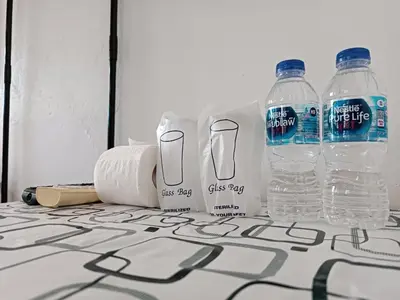 two bottles of water and toilet paper on a table at THE NAIYANGHOUSE in Nai Yang Beach