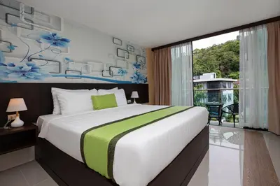 a bedroom with a large bed and a balcony at iCheck inn Sky Beach Ao Nang Krabi in Ao Nang Beach