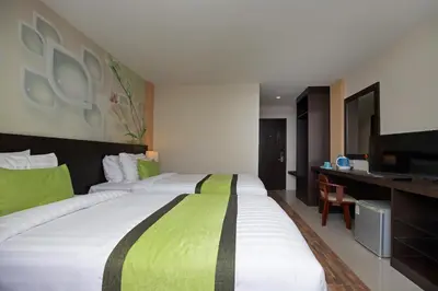a hotel room with a large bed and a television at iCheck inn Sky Beach Ao Nang Krabi in Ao Nang Beach