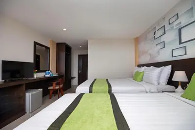 a hotel room with two beds and a television at iCheck inn Sky Beach Ao Nang Krabi in Ao Nang Beach