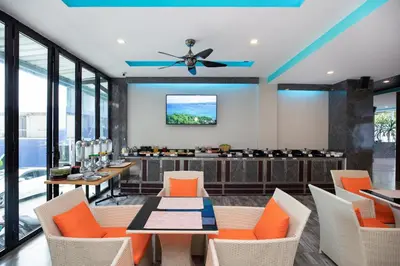 a dining room with orange chairs and a ceiling fan at iCheck inn Sky Beach Ao Nang Krabi in Ao Nang Beach