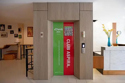 a wall with a sign in the middle of a room at iCheck inn Sky Beach Ao Nang Krabi in Ao Nang Beach
