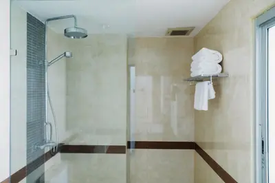 a bathroom with a shower with a glass door at Di Yana Patong in Patong Beach
