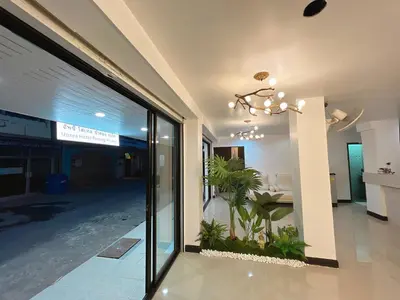 a lobby with a glass door with a plant at Upsea patong in Patong Beach