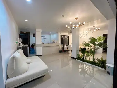 a living room with a white couch and plants at Upsea patong in Patong Beach