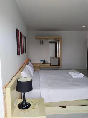 a bedroom with a bed and a table with a lamp at Urban Patong Residence in Patong Beach