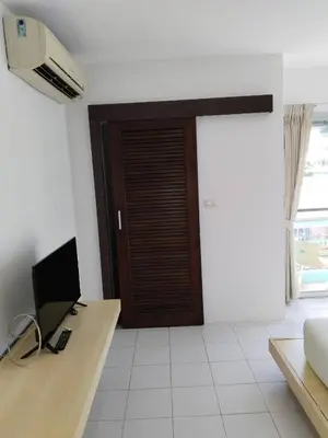 a room with a desk with a computer and a door at Urban Patong Residence in Patong Beach