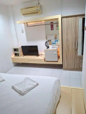 a room with a kitchen with a bed in it at Urban Patong Residence in Patong Beach