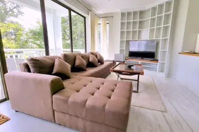 a living room with a couch and a television at Spacious 2BR Apartment ALM 2223 in Laguna, 10 min from BangTao Beach in Bang Tao Beach