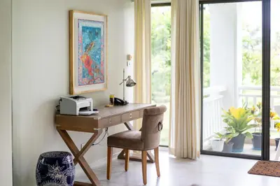 a home office with a wooden desk and a chair at Spacious 2BR Apartment ALM 2223 in Laguna, 10 min from BangTao Beach in Bang Tao Beach