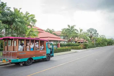 a trolley filled with people riding on a street at Spacious 2BR Apartment ALM 2223 in Laguna, 10 min from BangTao Beach in Bang Tao Beach
