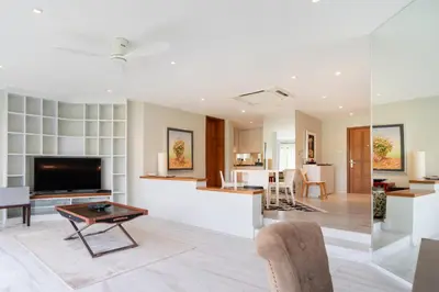 a living room with a television and a table at Spacious 2BR Apartment ALM 2223 in Laguna, 10 min from BangTao Beach in Bang Tao Beach