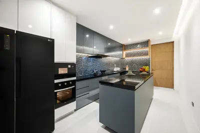 a kitchen with black cabinets and a black counter top at New 3BR Private Pool Villa with 5 Stars Resort Service in Rawai Beach
