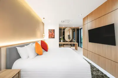 a hotel room with a large bed and a flat screen tv at New 3BR Private Pool Villa with 5 Stars Resort Service in Rawai Beach