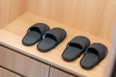 three pairs of flip flops sitting on a wooden drawer at New 3BR Private Pool Villa with 5 Stars Resort Service in Rawai Beach