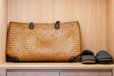 a brown bag sitting on a shelf next to shoes at New 3BR Private Pool Villa with 5 Stars Resort Service in Rawai Beach