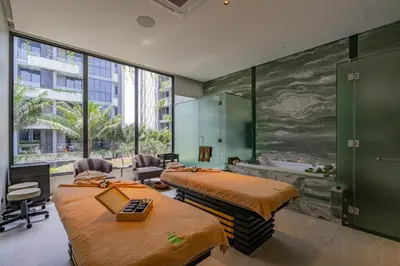 a room with two beds and a bath tub at La Green Hotel and Residence in Bang Tao Beach