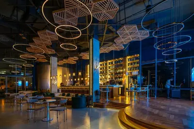 a restaurant with tables and chairs in a building at La Green Hotel and Residence in Bang Tao Beach
