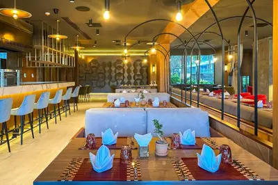 a restaurant with a long table and chairs at La Green Hotel and Residence in Bang Tao Beach