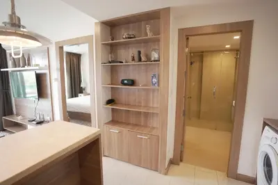 a kitchen with a walk in closet and a washing machine at Calypso Condo Rawai Nai Harn beach in Rawai Beach