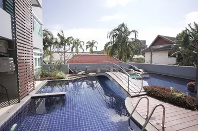 a swimming pool with a bridge in a building at Calypso Condo Rawai Nai Harn beach in Rawai Beach