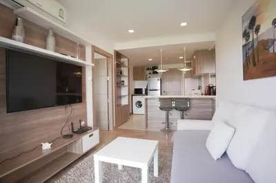a living room with a white couch and a table at Calypso Condo Rawai Nai Harn beach in Rawai Beach