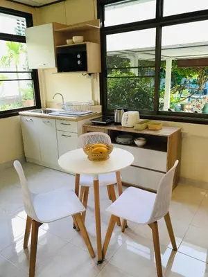 a small kitchen with a table and two chairs at Master Bedroom with private bathroom and kitchen in Phuket Town