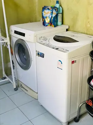 a washing machine sitting next to a washer at Master Bedroom with private bathroom and kitchen in Phuket Town