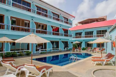 a hotel with a swimming pool in front of a building at O'Shop Residence Patong Beach in Patong Beach