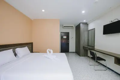 a hotel room with a bed and a flat screen tv at O'Shop Residence Patong Beach in Patong Beach
