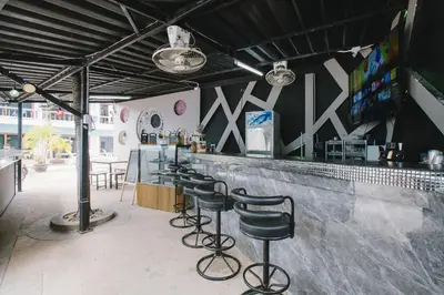 a bar with a row of stools in a restaurant at O'Shop Residence Patong Beach in Patong Beach