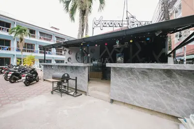 a bar with motorcycles parked outside of a building at O'Shop Residence Patong Beach in Patong Beach