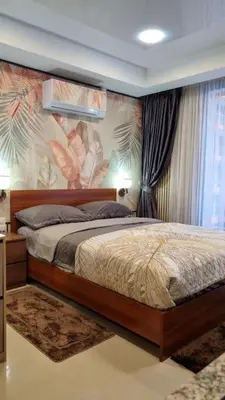 a bedroom with a bed with a painting on the wall at CB408 Apartament Beach condo 777 in Phuket Town