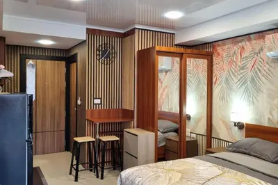 a bedroom with a bed and a desk at CB408 Apartament Beach condo 777 in Phuket Town