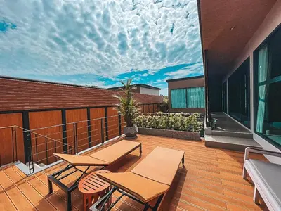 a balcony with two tables and chairs on a building at Le Villa Residence in Phuket Town
