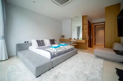 a bedroom with a bed and a living room at Botanica Foresta 4BR Luxury Villa with Pool by NLA in Bang Tao Beach