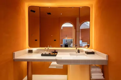 a bathroom with a sink and a large mirror at Hotel Adam Krabi in Ao Nang Beach
