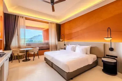 a hotel room with a bed and a table at Hotel Adam Krabi in Ao Nang Beach